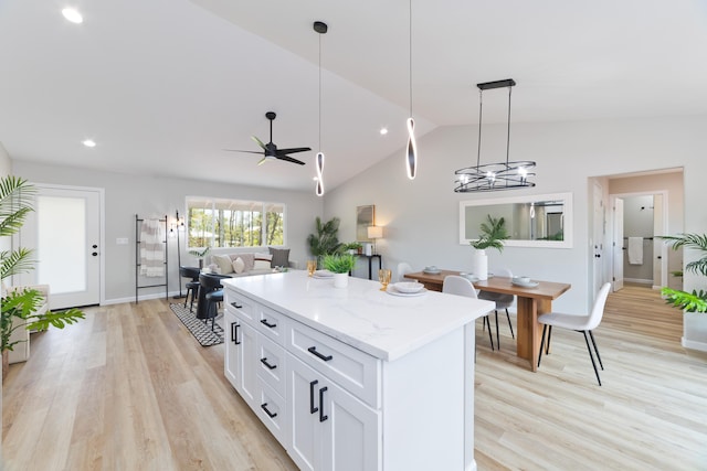 16-2148 Pukalani Dr, Pahoa, HI 96778 - kitchen featuring a kitchen island, light wood-type flooring, lofted ceiling, white cabinetry, and hanging light fixtures