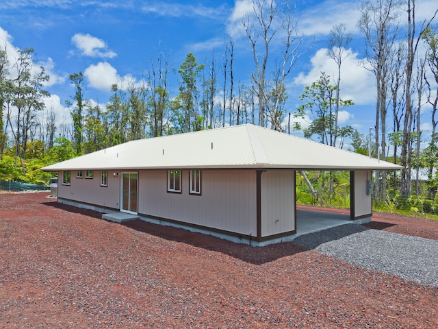 16-2148 Pukalani Dr, Pahoa, HI 96778 - view of front of property featuring gravel driveway, a carport, and a metal roof