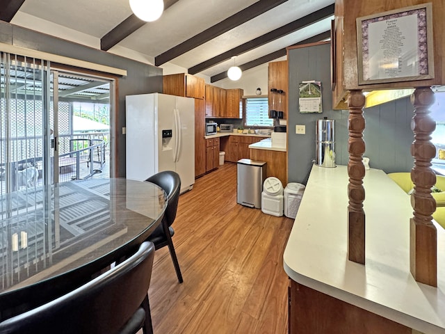 979-A Kumukoa St, Hilo, HI 96720 - kitchen with white fridge with ice dispenser, brown cabinets, light wood-style flooring, and healthy amount of natural light