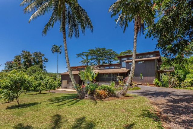 4417-B Kahili Makai St Unit D, Kilauea, HI 96754 - view of front facade featuring a front yard, driveway, and a garage