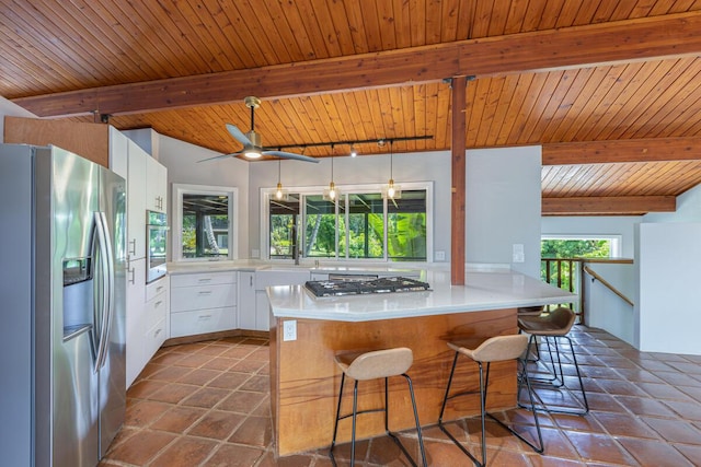 4417-B Kahili Makai St Unit D, Kilauea, HI 96754 - kitchen featuring stainless steel appliances, a peninsula, white cabinets, light countertops, and a kitchen bar