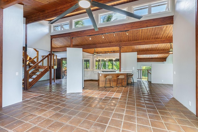 4417-B Kahili Makai St Unit D, Kilauea, HI 96754 - living area featuring ceiling fan, a wood ceiling with exposed beams, stairs, high vaulted ceiling, and plenty of natural light
