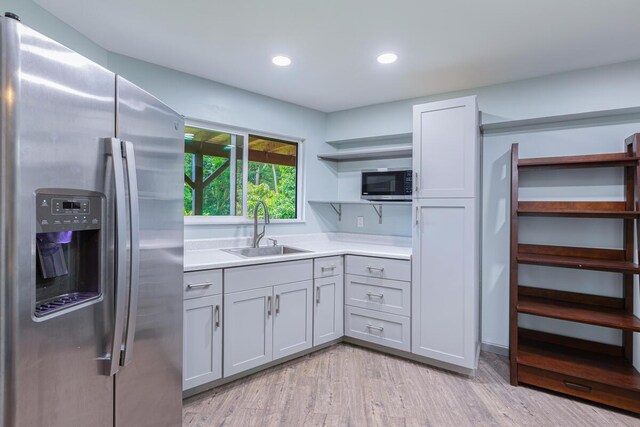 4417-B Kahili Makai St Unit D, Kilauea, HI 96754 - kitchen with appliances with stainless steel finishes, open shelves, light countertops, light wood-type flooring, and recessed lighting