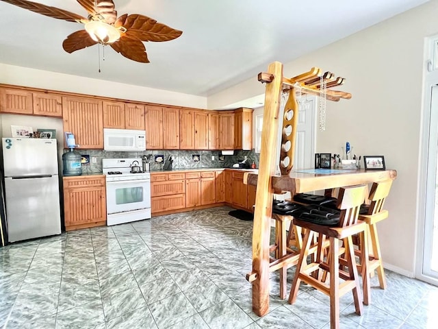 11-2920 S Apele Rd, Mountain View, HI 96771 - kitchen featuring white appliances, decorative backsplash, light marble finish floors, and a ceiling fan