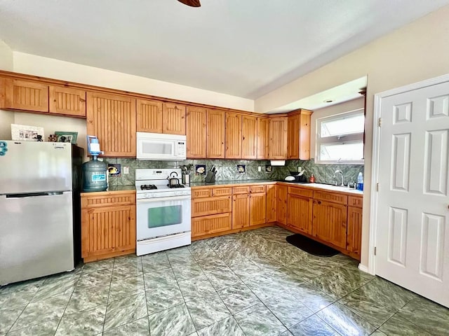 11-2920 S Apele Rd, Mountain View, HI 96771 - kitchen featuring white appliances, decorative backsplash, light marble finish floors, and brown cabinets