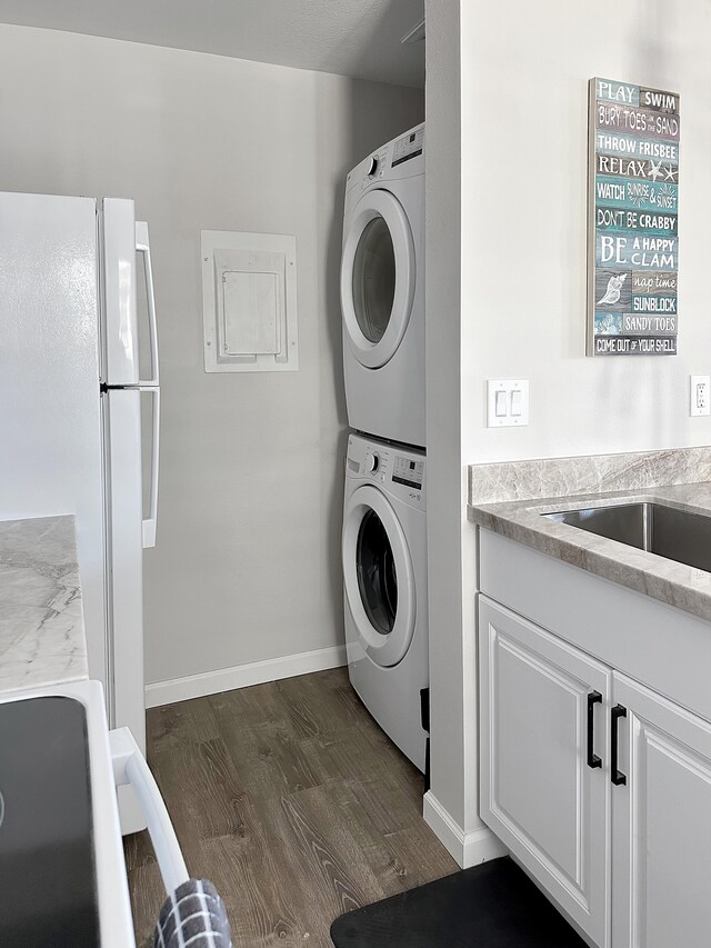 68-3831 Lua Kula St Unit H202, Waikoloa, HI 96738 - laundry room featuring estacked washer and dryer and dark wood-style flooring