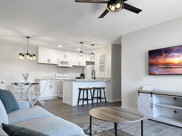 68-3831 Lua Kula St Unit H202, Waikoloa, HI 96738 - living area featuring dark wood finished floors, ceiling fan, recessed lighting, and a chandelier