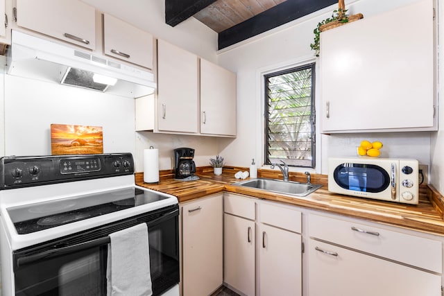 76-6259 Alii Dr Unit 332, Kailua-Kona, HI 96740 - kitchen featuring range with electric cooktop, butcher block counters, white microwave, under cabinet range hood, and white cabinets