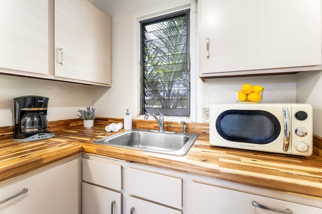 76-6259 Alii Dr Unit 332, Kailua-Kona, HI 96740 - kitchen with butcher block countertops and white cabinets
