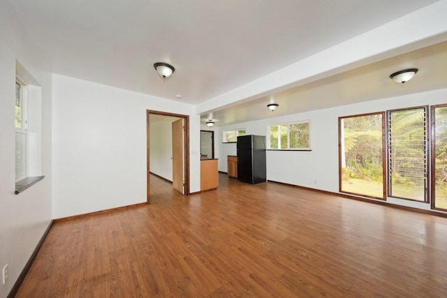 11-2972 Alii Papa St, Volcano, HI 96785 - unfurnished living room with dark wood finished floors and baseboards