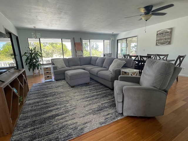 94-5868 Kanaloa Pl, Naalehu, HI 96772 - living area featuring a chandelier, wood finished floors, and ceiling fan