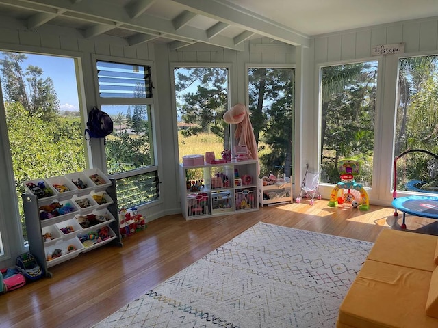 94-5868 Kanaloa Pl, Naalehu, HI 96772 - sunroom with wood finished floors, beamed ceiling, plenty of natural light, and a wooden deck