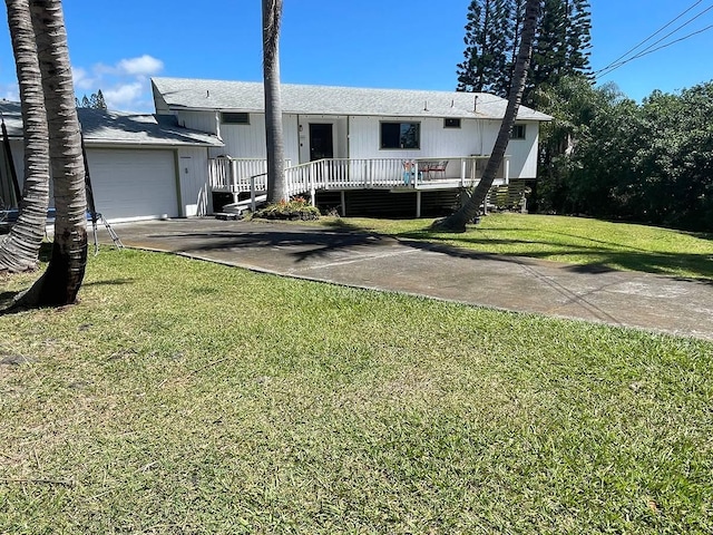 94-5868 Kanaloa Pl, Naalehu, HI 96772 - view of front of house featuring driveway, an attached garage, and a front yard