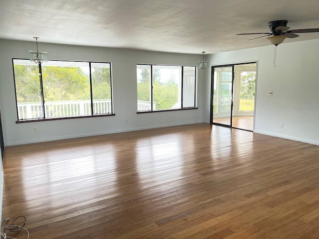 94-5868 Kanaloa Pl, Naalehu, HI 96772 - empty room with a chandelier, wood finished floors, and ceiling fan