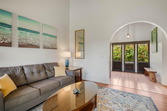 1901 Poipu Rd Unit 633, Koloa, HI 96756 - living area featuring wood finished floors, arched walkways, and a towering ceiling