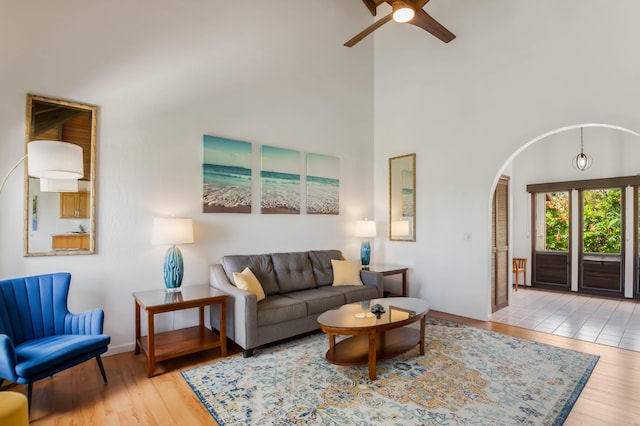 1901 Poipu Rd Unit 633, Koloa, HI 96756 - living room with arched walkways, wood finished floors, a towering ceiling, and a ceiling fan