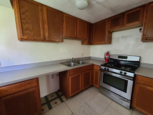 130 Popolo St, Hilo, HI 96720 - kitchen with stainless steel gas range oven, brown cabinets, and light countertops