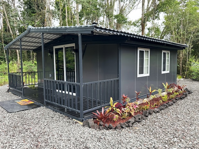 15-594 S Puni Mauka Loop, Pahoa, HI 96778 - view of side of home featuring a metal roof