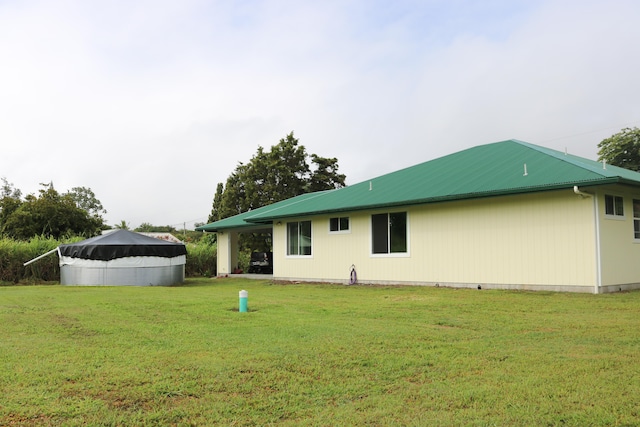 15-1393 29th Ave, Keaau, HI 96749 - back of house with a metal roof and a yard