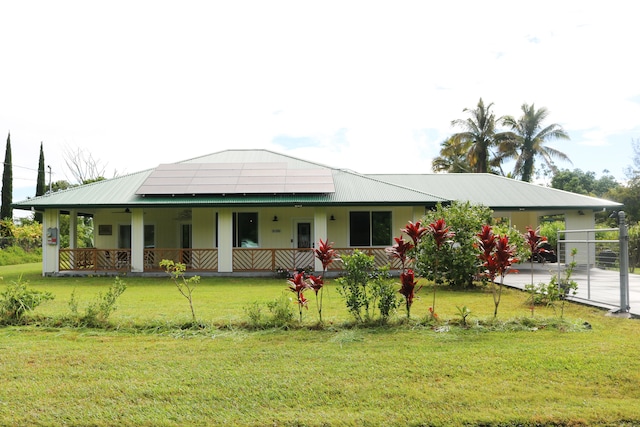 15-1393 29th Ave, Keaau, HI 96749 - view of front of house with a metal roof, a front yard, a ceiling fan, covered porch, and an attached carport