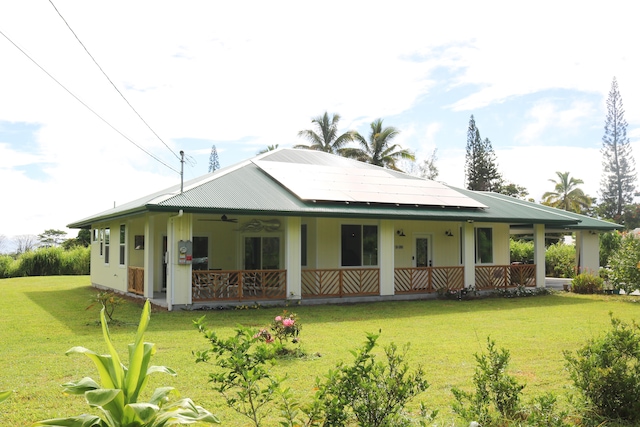 15-1393 29th Ave, Keaau, HI 96749 - back of property with ceiling fan, a yard, covered porch, and a metal roof