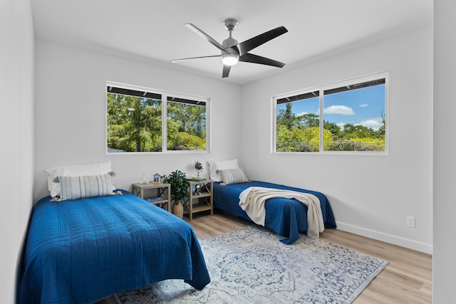 15-1698 5th Ave, Keaau, HI 96749 - bedroom with multiple windows, wood finished floors, and ceiling fan
