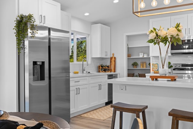 15-1698 5th Ave, Keaau, HI 96749 - kitchen featuring appliances with stainless steel finishes, decorative backsplash, light countertops, white cabinets, and recessed lighting