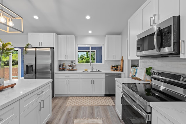 15-1698 5th Ave, Keaau, HI 96749 - kitchen with appliances with stainless steel finishes, white cabinets, backsplash, and recessed lighting