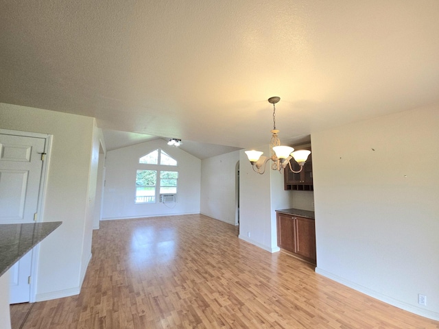 15-1581 Railroad Ave, Keaau, HI 96749 - unfurnished room with a chandelier, light wood-style floors, and lofted ceiling