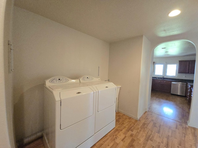 15-1581 Railroad Ave, Keaau, HI 96749 - laundry room with washer and dryer, light wood-style flooring, arched walkways, and recessed lighting