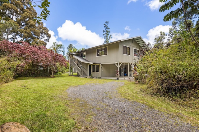 13-3401 Alapai St, Pahoa, HI 96778 - view of front facade with a front yard, driveway, and stairs