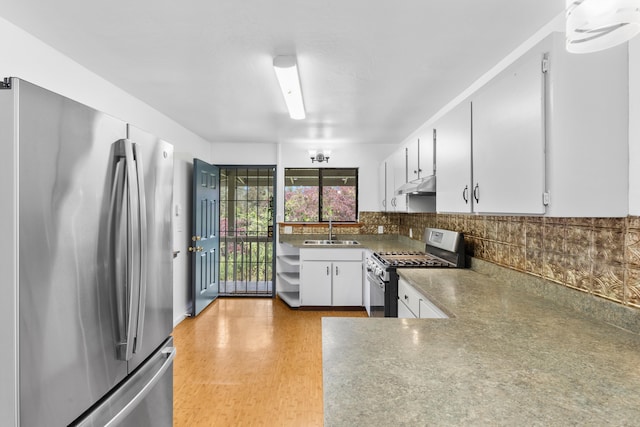13-3401 Alapai St, Pahoa, HI 96778 - kitchen with stainless steel appliances, under cabinet range hood, tasteful backsplash, white cabinets, and light wood finished floors
