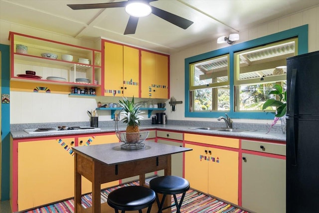 14-3342 Kaululaau Rd Unit 3, Pahoa, HI 96778 - kitchen featuring freestanding refrigerator, white cooktop, yellow cabinetry, open shelves, and a ceiling fan