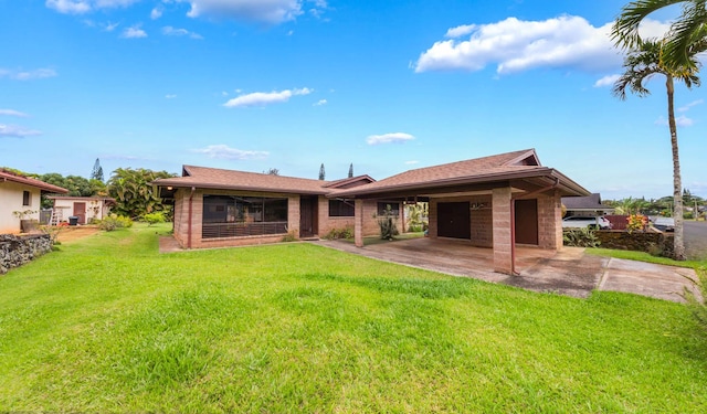 328 Molo St, Kapaa, HI 96746 - back of property featuring a garage, a lawn, a patio area, driveway, and brick siding