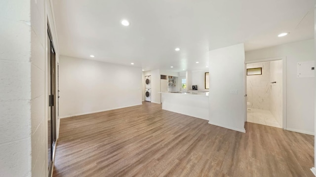 328 Molo St, Kapaa, HI 96746 - unfurnished living room featuring stacked washer and clothes dryer, light wood-style flooring, and recessed lighting