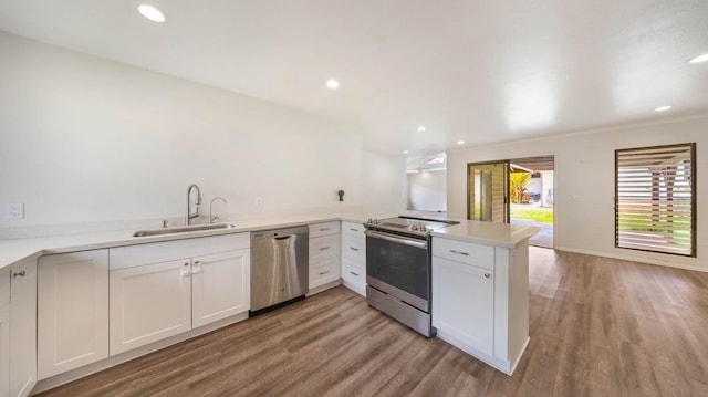 328 Molo St, Kapaa, HI 96746 - kitchen featuring stainless steel appliances, light wood-type flooring, a peninsula, white cabinetry, and recessed lighting