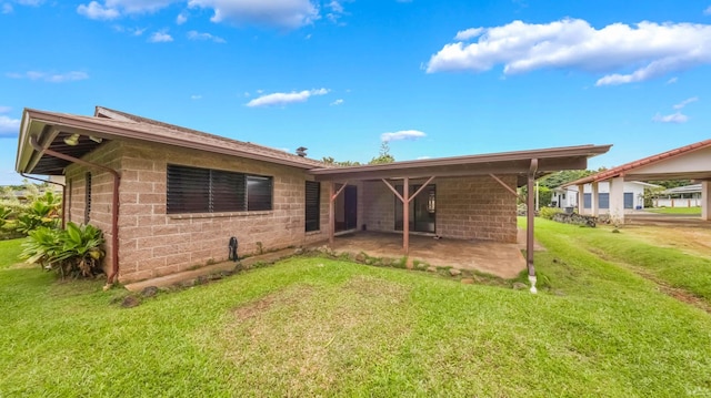 328 Molo St, Kapaa, HI 96746 - back of property with a lawn and a patio area