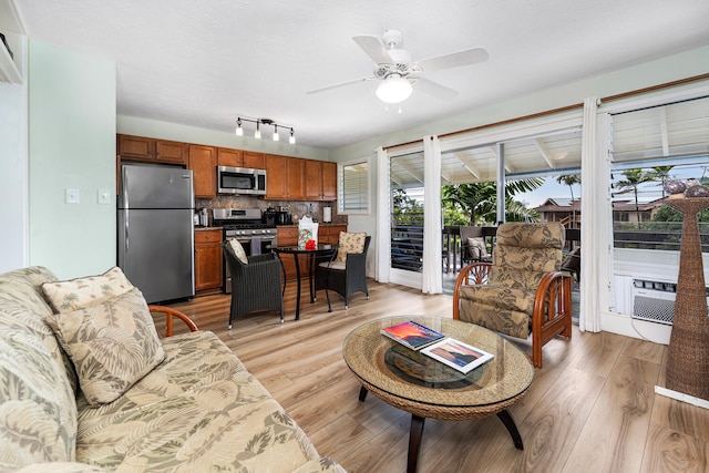 75-6008 Alii Dr Unit 219, Kailua-Kona, HI 96740 - living area with a ceiling fan, light wood finished floors, and cooling unit