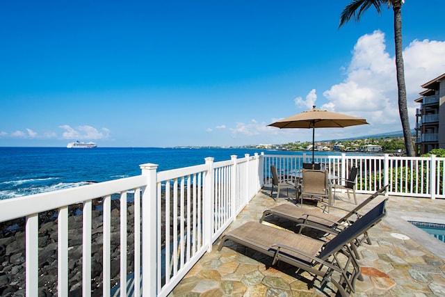 75-6008 Alii Dr Unit 219, Kailua-Kona, HI 96740 - view of patio with a water view and outdoor dining space