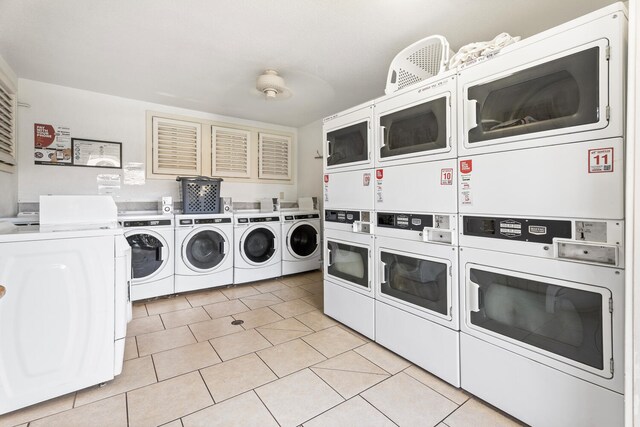 75-6008 Alii Dr Unit 219, Kailua-Kona, HI 96740 - shared laundry room featuring stacked washer / dryer, washing machine and clothes dryer, and light tile patterned flooring