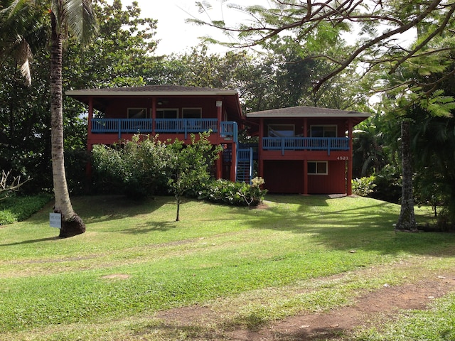 4523 Uku Lii Pl, Hanalei, HI 96714 - back of house with a wooden deck, a lawn, and stairs