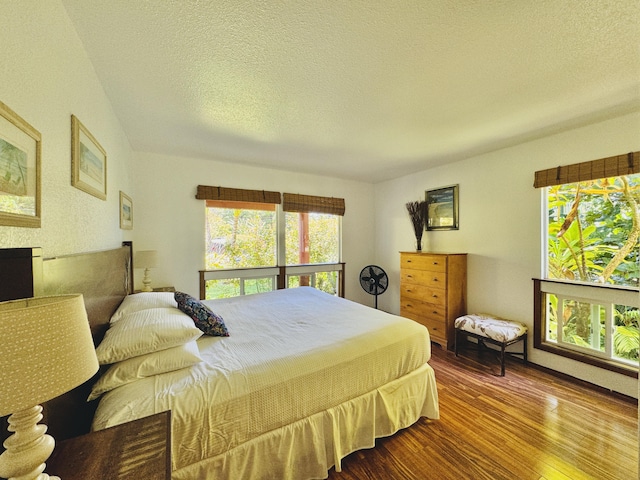 4523 Uku Lii Pl, Hanalei, HI 96714 - bedroom with wood finished floors, multiple windows, and a textured ceiling