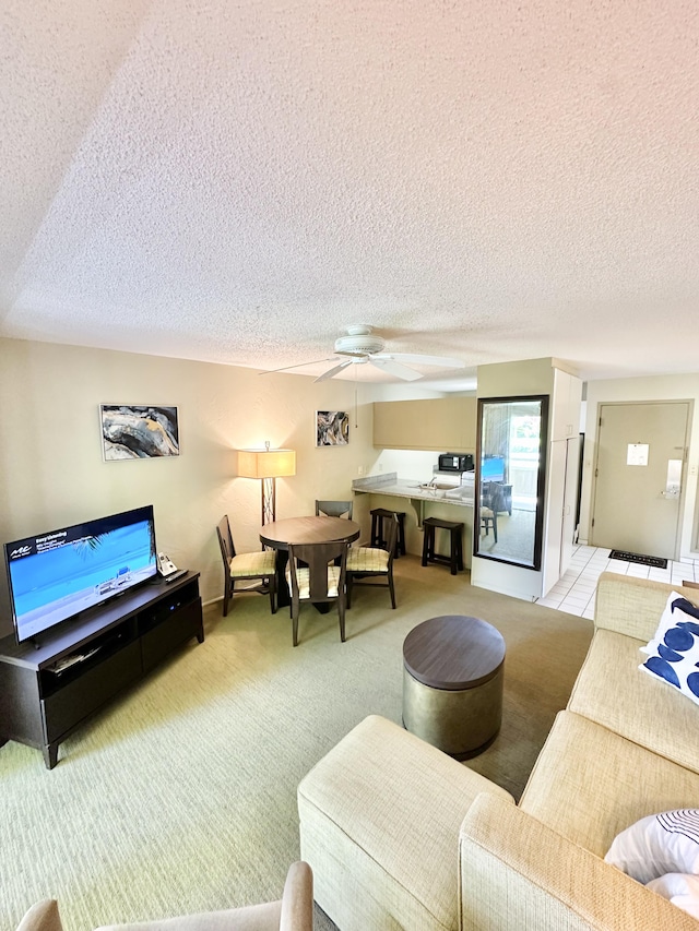 525 Aleka Lp Unit A2, Kapaa, HI 96746 - living room featuring a textured ceiling, a ceiling fan, and light colored carpet