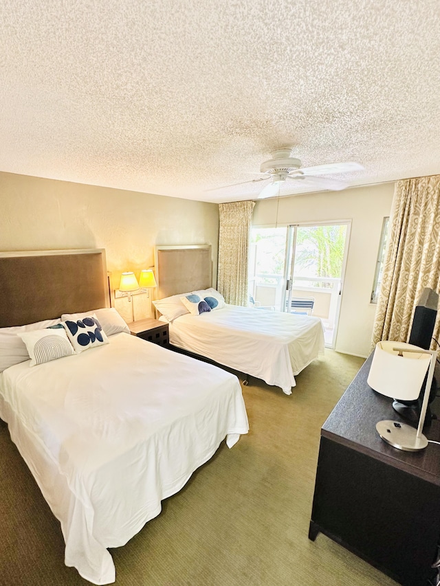 525 Aleka Lp Unit A2, Kapaa, HI 96746 - bedroom featuring a textured ceiling, carpet flooring, and access to exterior