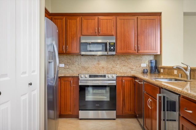 68-1122 Na Ala Hele Rd Unit E4, Kamuela, HI 96743 - kitchen with stainless steel appliances, beverage cooler, brown cabinets, light stone countertops, and backsplash