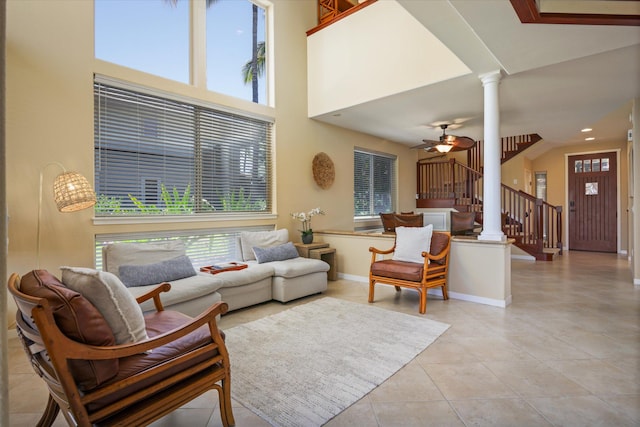 68-1122 Na Ala Hele Rd Unit E4, Kamuela, HI 96743 - living room with light tile patterned flooring, decorative columns, stairway, a ceiling fan, and a high ceiling