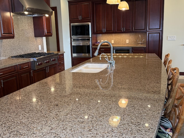 62-3600 Amaui Pl Unit 345, Kamuela, HI 96743 - kitchen with appliances with stainless steel finishes, ventilation hood, light stone counters, and tasteful backsplash