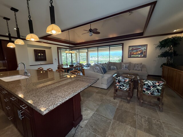 62-3600 Amaui Pl Unit 345, Kamuela, HI 96743 - living area featuring a ceiling fan, a raised ceiling, dark stone finish floors, and ornamental molding