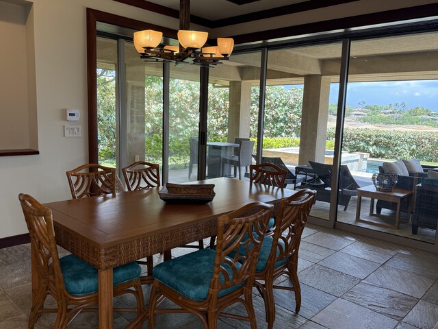 62-3600 Amaui Pl Unit 345, Kamuela, HI 96743 - dining room with a chandelier, healthy amount of natural light, and stone tile flooring