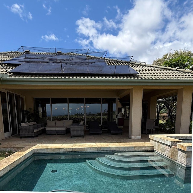 62-3600 Amaui Pl Unit 345, Kamuela, HI 96743 - back of house featuring outdoor lounge area, roof mounted solar panels, an in-ground hot tub, and a patio area